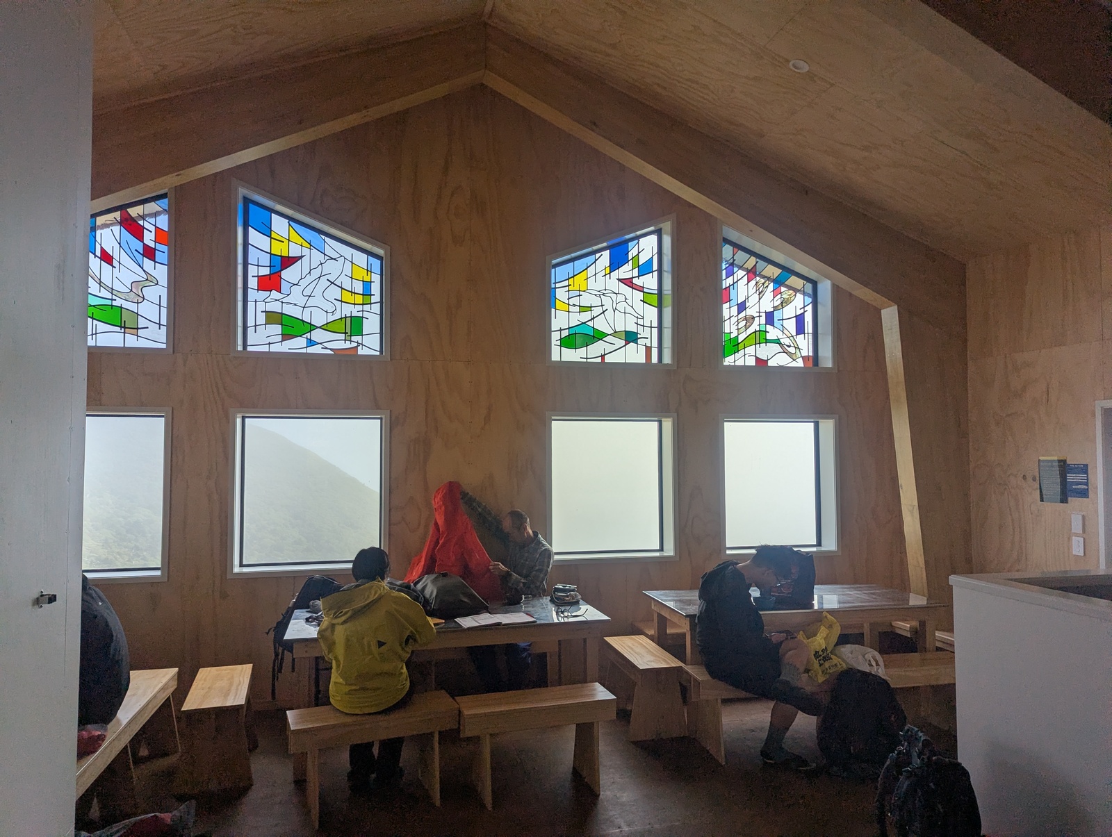 The interior of the new Pouakai Hut, with some lovely coloured-glass windows