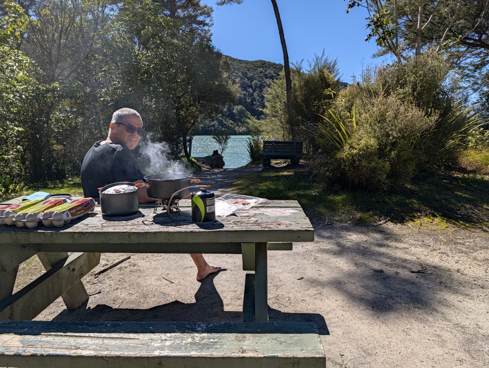 Cooking bacon and eggs for lunch outside the Bark Bay hut; inside, I had set off the smoke alarms
